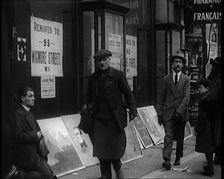 Male Ex-Services Civilian Selling Paintings on a Pavement Whilst Other Civilians are Walk..., 1920s. Creator: British Pathe Ltd