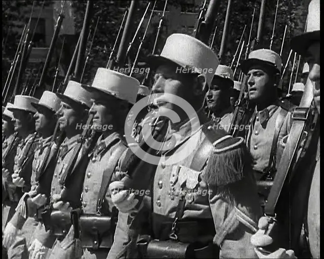 Male French Foreign Legion Soldiers Marching in a Bastille Day Military Parade, 1939. Creator: British Pathe Ltd.
