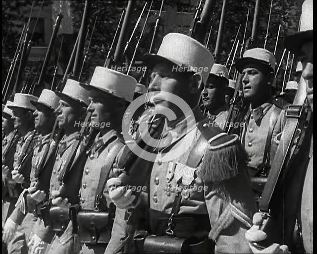 Male French Foreign Legion Soldiers Marching in a Bastille Day Military Parade, 1939. Creator: British Pathe Ltd.