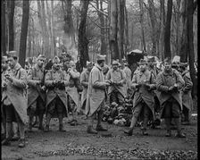Male French Soldier Stand in a Wood Eating, 1924. Creator: British Pathe Ltd