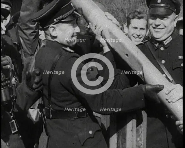 Male German Officers Removing a Barrier at a Checkpoint on the Border Between Germany and..., 1938. Creator: British Pathe Ltd.
