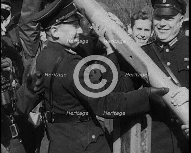 Male German Officers Removing a Barrier at a Checkpoint on the Border Between Germany and..., 1938. Creator: British Pathe Ltd.