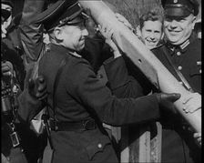 Male German Officers Removing a Barrier at a Checkpoint on the Border Between Germany and..., 1938. Creator: British Pathe Ltd