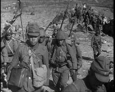 Male Japanese Soldiers With Rifles Walking up a Hillside, Near the City of Hankow, 1937. Creator: British Pathe Ltd