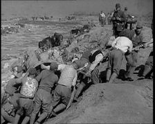 Male Japanese Soldiers Hauling a Cart up a Beach Near Shanghai, 1937. Creator: British Pathe Ltd