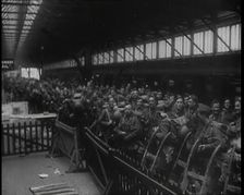 Male Members of the British Expeditionary Force Waiting at a Large Railway Station Before..., 1939. Creator: British Pathe Ltd