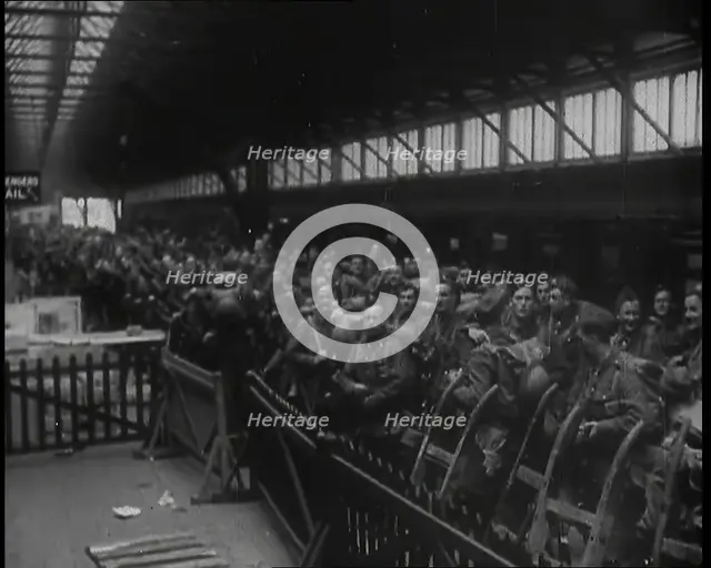 Male Members of the British Expeditionary Force Waiting at  a Large Railway Station Before..., 1939. Creator: British Pathe Ltd.