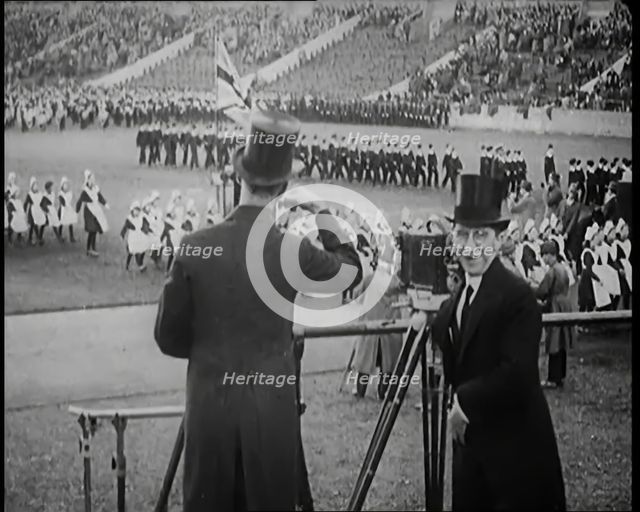 Male Newsreel Camera Operators Carrying Tripods and Equipment, 1920s. Creator: British Pathe Ltd.
