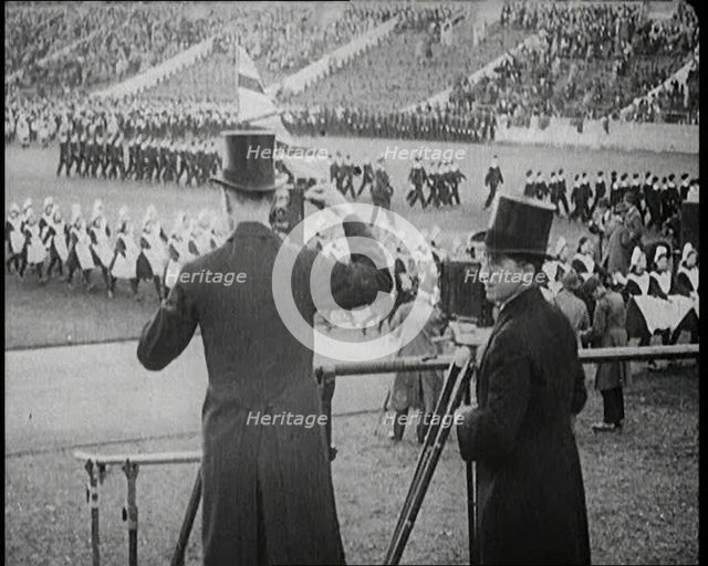 Male Newsreel Camera Operators Carrying Tripods and Equipment, 1920s. Creator: British Pathe Ltd.