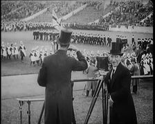 Male Newsreel Camera Operators Carrying Tripods and Equipment, 1920s. Creator: British Pathe Ltd