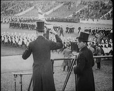 Male Newsreel Camera Operators Carrying Tripods and Equipment, 1920s. Creator: British Pathe Ltd