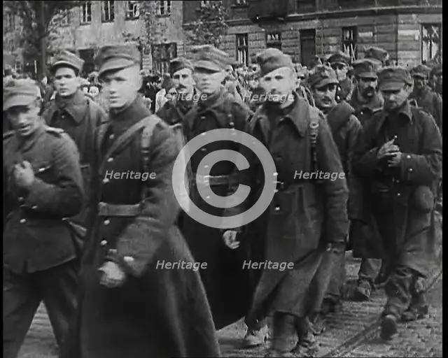 Male Polish Soldiers Walking Along a Warsaw Street, 1939. Creator: British Pathe Ltd.