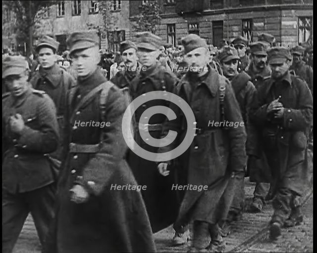 Male Polish Soldiers Walking Along a Warsaw Street, 1939. Creator: British Pathe Ltd.