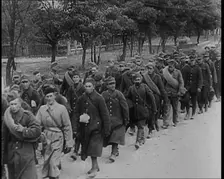 Male Polish Soldiers Walking Along an Unpaved Road Beside a Line of Trees With Fences Beyond, 1939. Creator: British Pathe Ltd