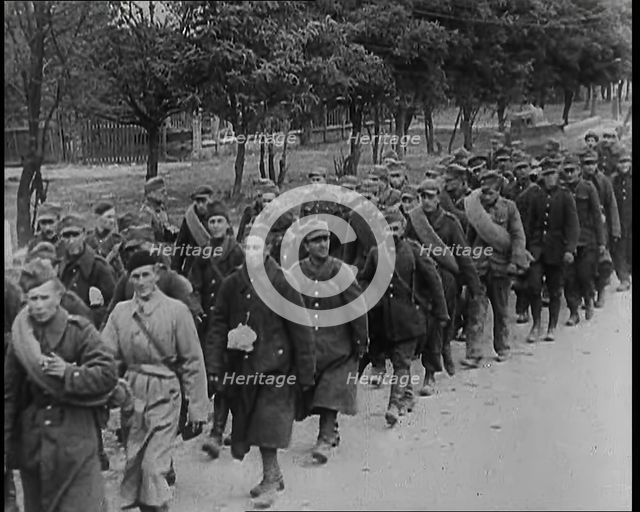Male Polish Soldiers Walking Along an Unpaved Road Beside a Line of Trees With Fences Beyond, 1939. Creator: British Pathe Ltd.