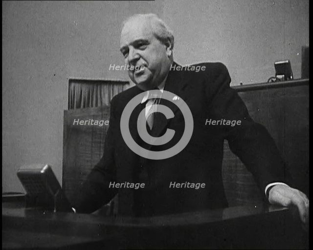 Male Representative of the League of Nations Speaking at Lectern in Front of Microphone, 1937. Creator: British Pathe Ltd.