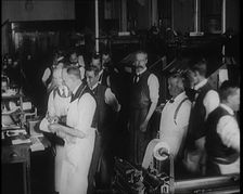 Male Screen Printers Working in a News Room, Using Various Pieces of Printing Machinery, 1921. Creator: British Pathe Ltd