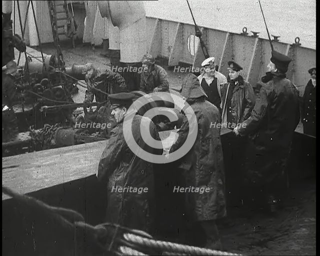 Male Ship's Crew Standing Near Rigging and Machinery on Deck of a Freighter, 1939. Creator: British Pathe Ltd.