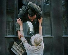 Male Soldier Kissing Female Civilian from the Window of a Train, 1929. Creator: British Pathe Ltd