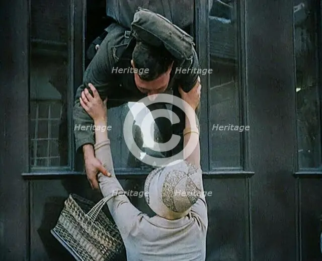 Male Soldier Kissing Female Civilian from the Window of a Train, 1929. Creator: British Pathe Ltd.