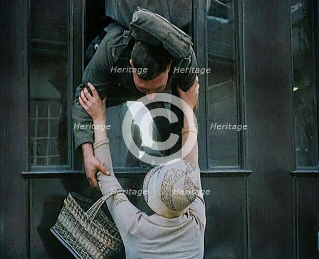 Male Soldier Kissing Female Civilian from the Window of a Train, 1929. Creator: British Pathe Ltd.