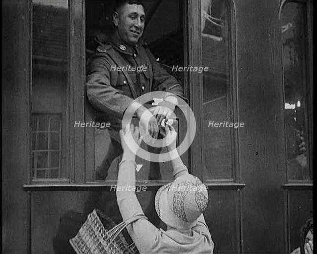 Male Soldier Kissing Female Civilian from the Window of a Train, 1929. Creator: British Pathe Ltd.