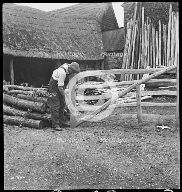 Man making a field gate in the village of Aston, Cote, Shifford and Chimney, Oxfordshire, 1930-50. Creator: George R Long.