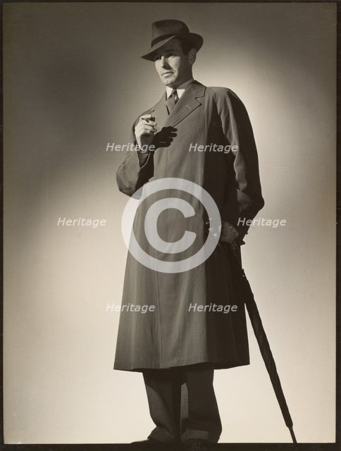 Man modeling trench coat, about 1943. Creator: Gunther Krampf.