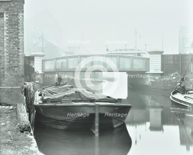 Man mooring a barge by a river bank, Poplar, London, 1905.  Artist: Unknown.