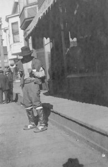 Man outside store, between c1900 and 1916. Creator: Unknown