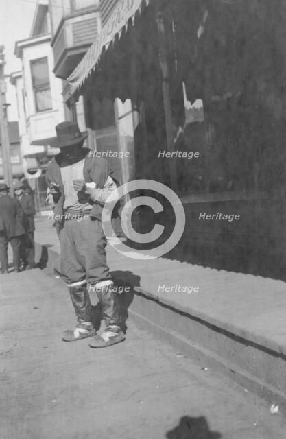 Man outside store, between c1900 and 1916. Creator: Unknown.