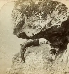 Man on a cliff overlooking Naeroyfjord, Sogne, Norway. Creator: Bert Underwood