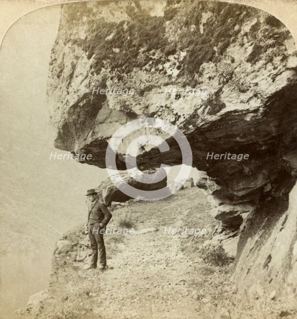 Man on a cliff overlooking Naeroyfjord, Sogne, Norway. Creator: Bert Underwood.