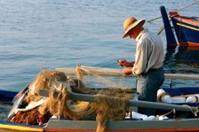 Man on board a fishing boat, Sami, Kefalonia, Greece. Creator: Peter Thompson