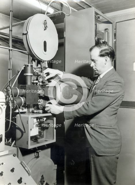 Man operating film projector, c1955. Creator: Arthur Charles Kirby Ware.