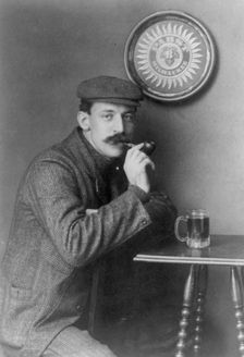 Man at table with pipe and mug under "Pabst - Milwaukee" sign - C.C. Jones, between c1890 and c1910. Creator: Frances Benjamin Johnston