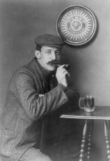 Man at table with pipe and mug under "Pabst - Milwaukee" sign - C.C. Jones, between c1890 and c1910. Creator: Frances Benjamin Johnston