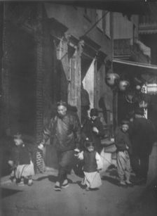 Man and two boys walking along a street, Chinatown, San Francisco, between 1896 and 1906. Creator: Arnold Genthe