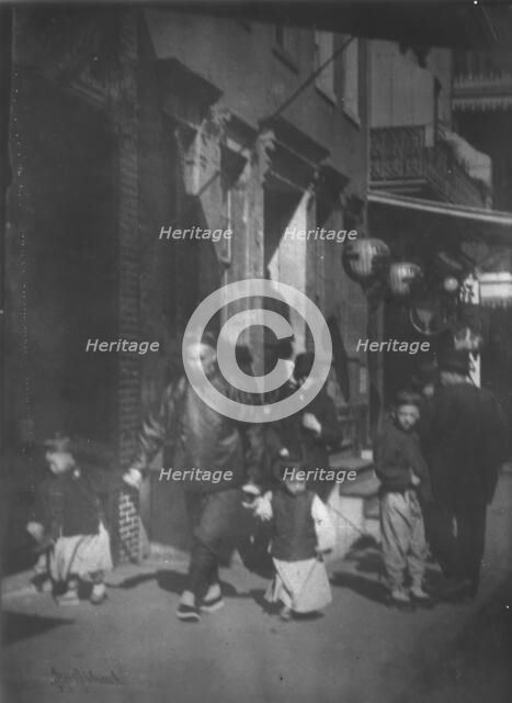 Man and two boys walking along a street, Chinatown, San Francisco, between 1896 and 1906. Creator: Arnold Genthe.