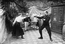Man and woman fencing (?), between c1910 and c1915. Creator: Bain News Service