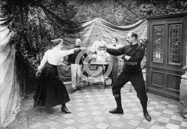 Man and woman fencing (?), between c1910 and c1915. Creator: Bain News Service.