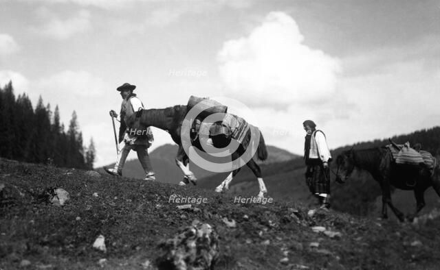 Man and woman leading horses, Bistrita Valley, Moldavia, north-east Romania, c1920-c1945. Artist: Adolph Chevalier