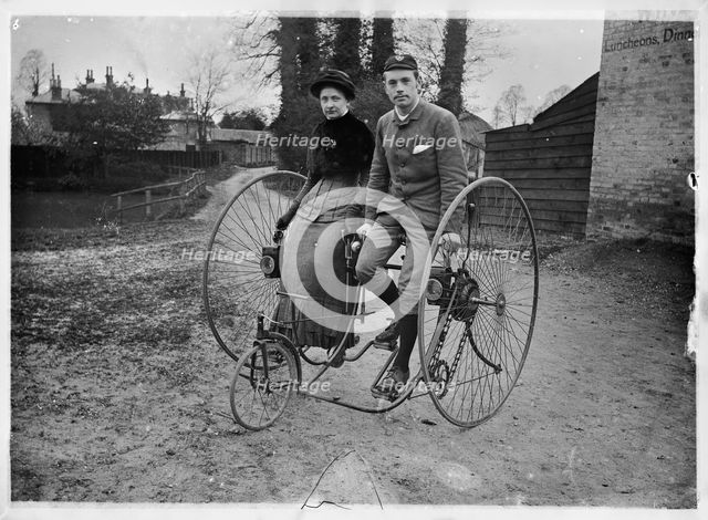 Man and a woman sitting on a double tricycle, England, c1890. Creator: Unknown.