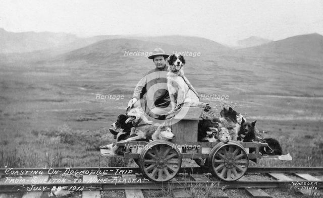 Man and dogs on rail cart trip from Shelton to Nome, 1912. Creator: Unknown.
