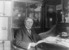 Man (banker?) seated at desk at American Security and Trust Co., Washington, D.C., c1890 - c1950. Creator: Frances Benjamin Johnston