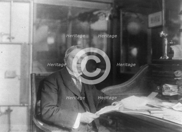 Man (banker?) seated at desk at American Security and Trust Co., Washington, D.C., c1890 - c1950. Creator: Frances Benjamin Johnston.