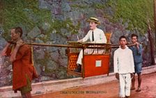 Man being carried on a Sedan chair, Hong kong, 20th century