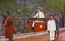 Man being carried on a Sedan chair, Hong kong, 20th century