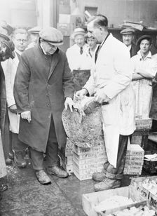 Man choosing fish at Billingsgate Market, London, (c1930s?). Creator: Unknown