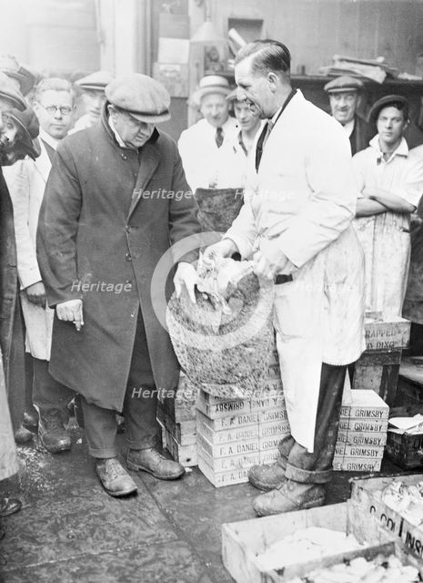 Man choosing fish at Billingsgate Market, London, (c1930s?). Creator: Unknown.